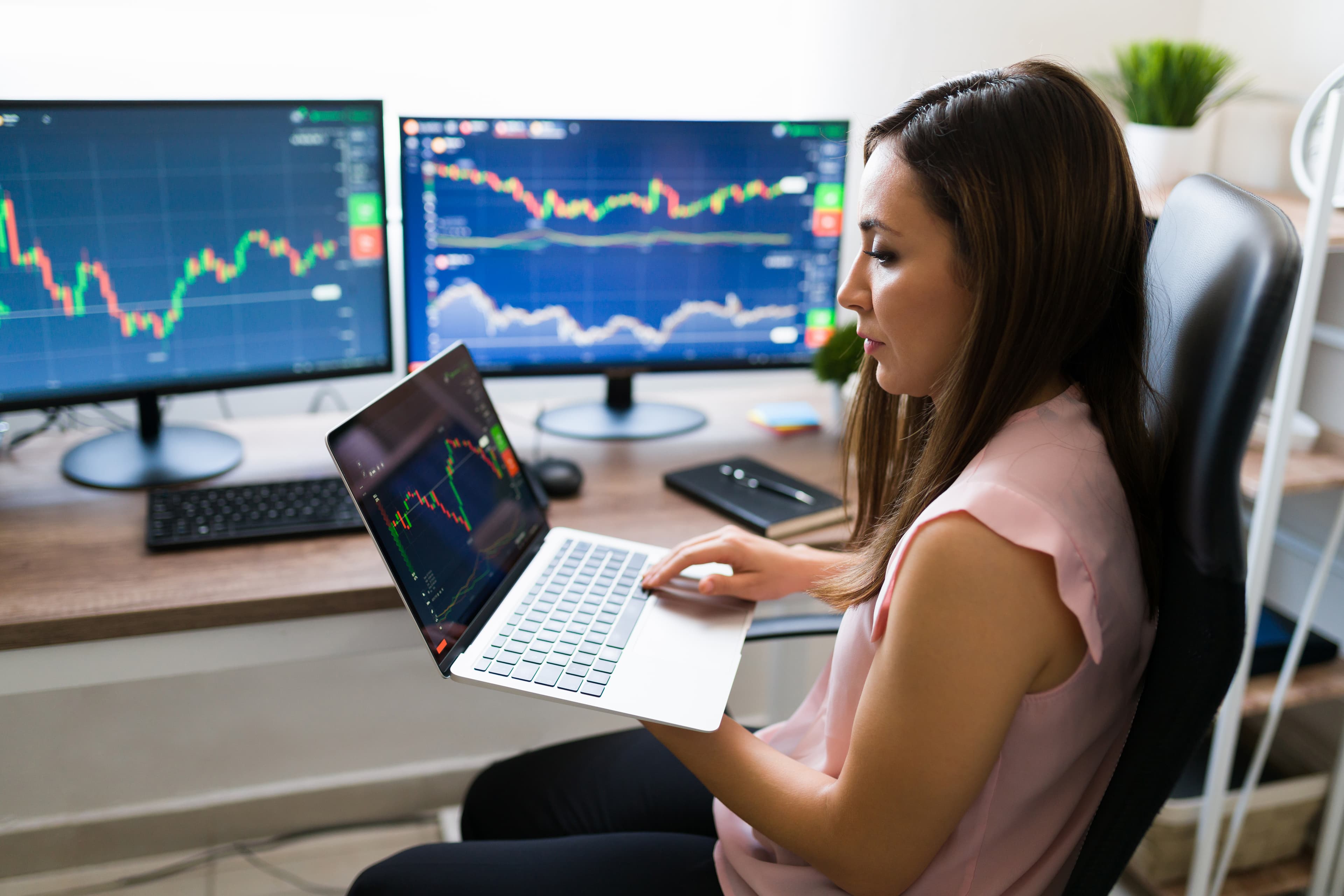 Hispanic woman trader managing trading psychology and emotions while working on futures prop firm evaluation from home